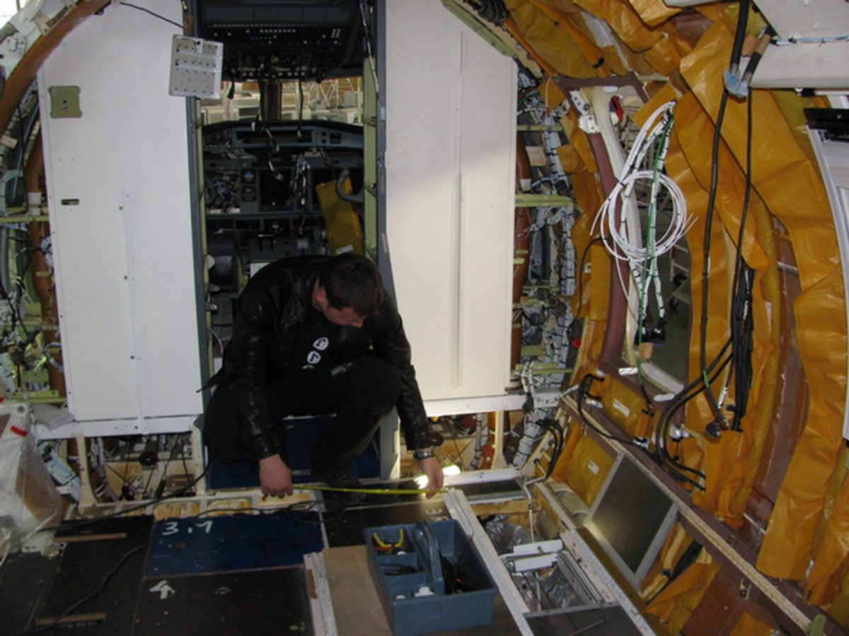 TGT engineer performing on-site measurements inside an aircraft